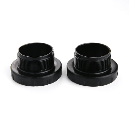 Two black press-fit bottom bracket cups with threaded openings and a flat mounting base