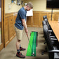 Mini putting mat with green track and push rod, used by a golfer indoors