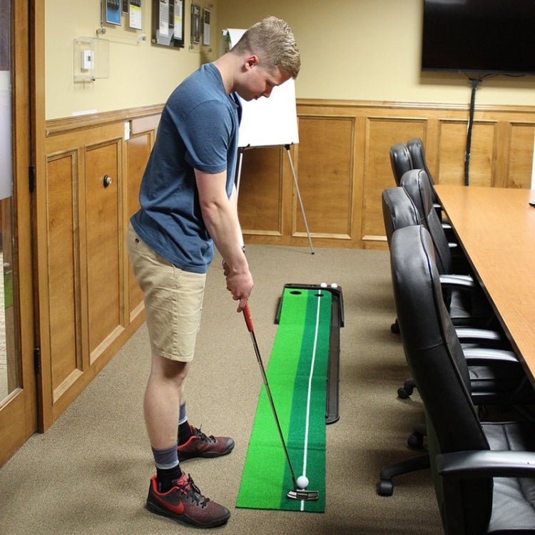 Mini putting mat with green track and push rod, used by a golfer indoors