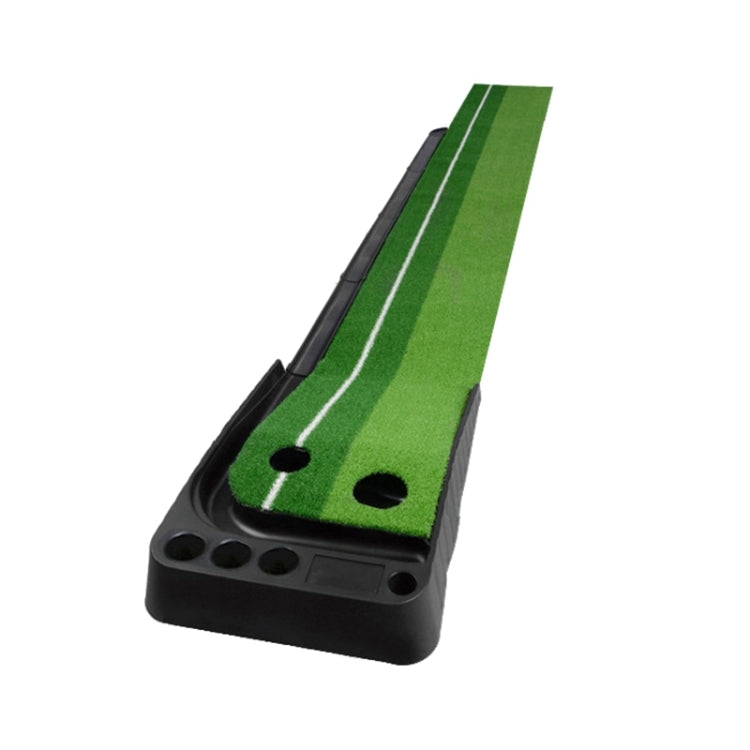 Green golf mini putting mat trainer on black base with push-rod channel for balls