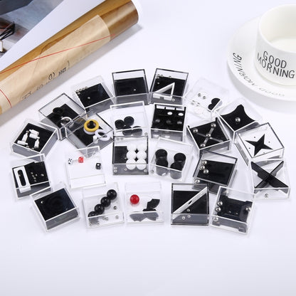 Assorted reducer toy set boxes with clear compartments and black-and-white balance pieces