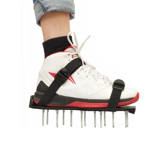 Spiked garden shoe attachment for white sneakers with black straps and metal spikes