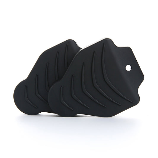 Black rubber cleat protective covers with raised tread ridges and round mounting holes