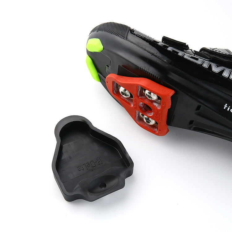 Black rubber cleat cover cap with hole, shown near a cycling shoe sole, LOOK KEO
