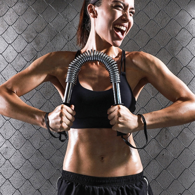 Arm strength spring grip trainer in hands with silver coiled U-shaped springs and black grips