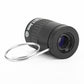 Black mini telescope angled view with ridged ring and purple-tinted lens glass