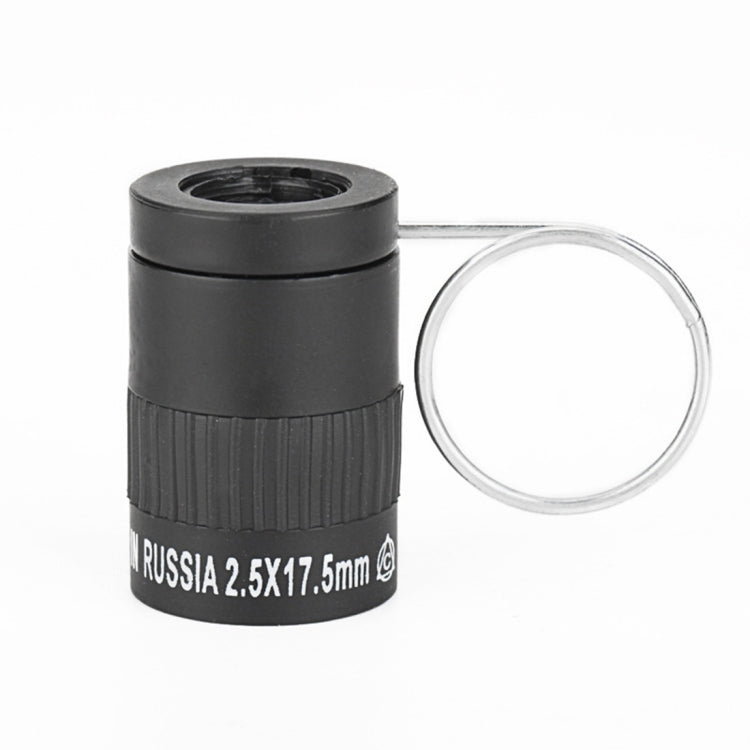 Black mini telescope with ridged grip and metal finger loop; text band on body