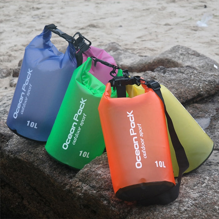 Colorful waterproof roll-top dry bags with shoulder straps, shown together