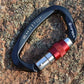 XINDA D-shaped climbing carabiner with dark body, red locking sleeve, and silver gate