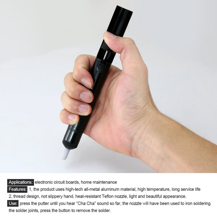 Black solder desoldering pump held in hand with white nozzle tip
