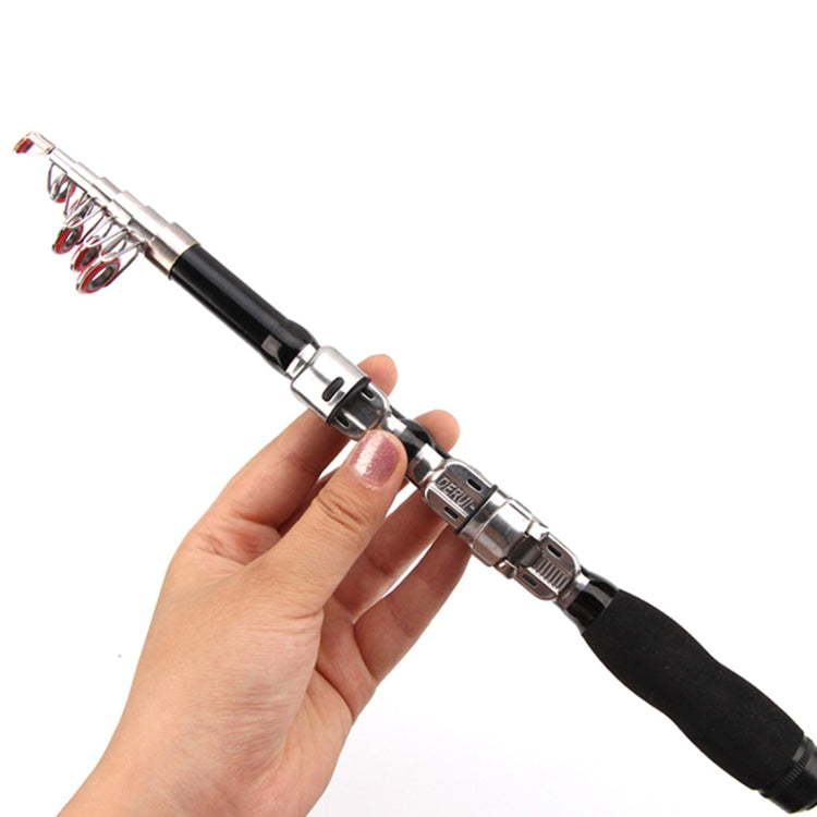 Fishing rod with black handle held in hand, silver reel seat and guide rings