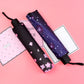Two umbrellas: black with pink flowers and navy with starry dots
