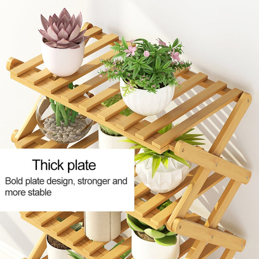 Collapsible wooden plant shelf with four slatted levels and folded X-frame support