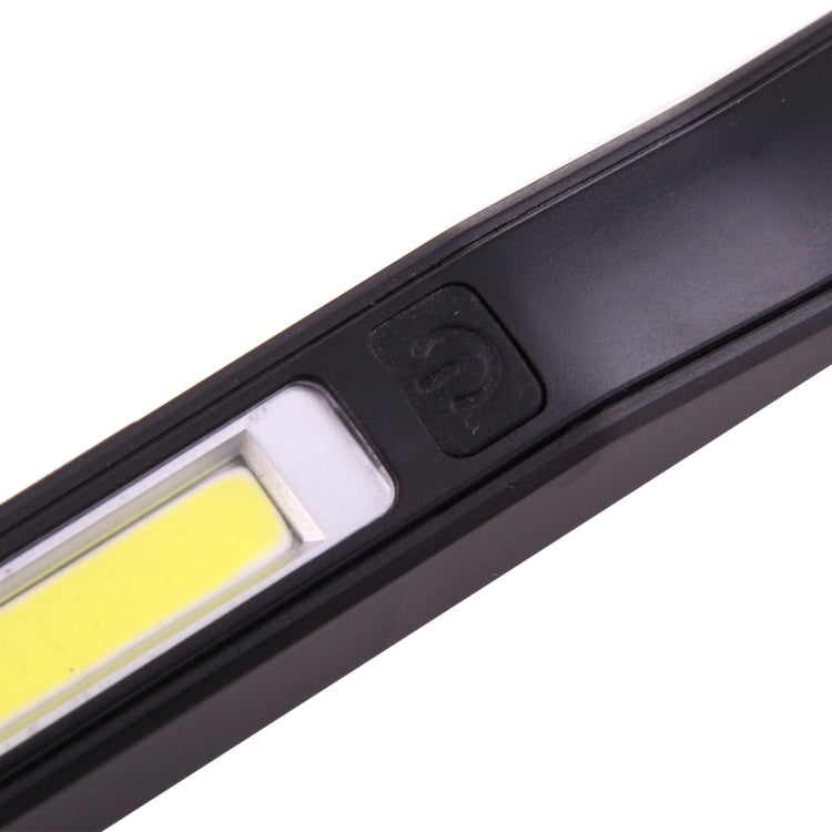Close-up of black COB LED pen light power button and glowing LED panel