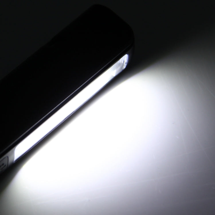 Black COB LED pen light casting a bright beam from the lens