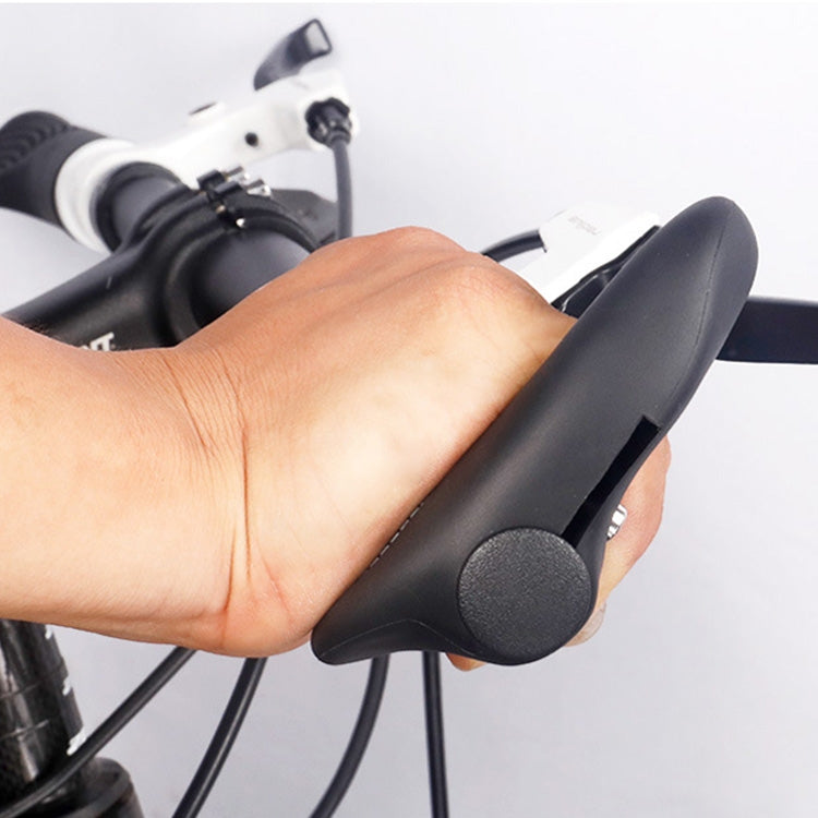 Hand installing black rubber horn handlebar grip; gray textured pad visible.