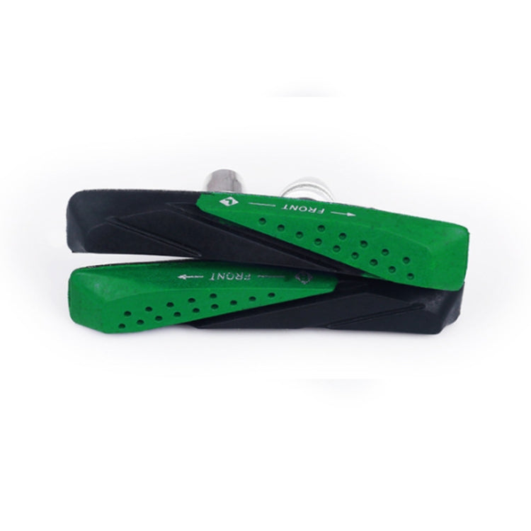 Green and black bicycle brake pads with ventilation holes, side view