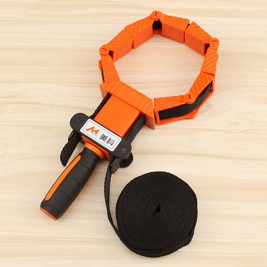 Folding woodworking binding clamp with orange plastic frame and black nylon strap