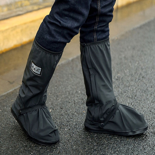 Black high-tube rain boots with drawstring cuffs and logo patch, mid-calf.