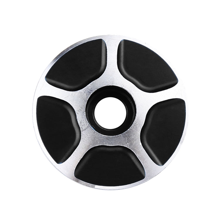 CNC aluminum bike headset cap, round silver face with four black pads and ring hole