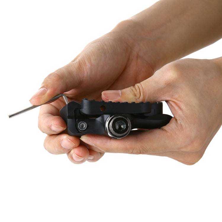 Hands adjusting black KEO-style locking pedal with Allen key