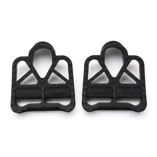 Two black SPD-SL style cleat adapters side by side with triangular grip cutouts