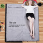 Gray sleeping bag opened flat with dark trim and hood at one end
