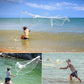 Fisherman casting a throw fishing net over shallow water with net spread