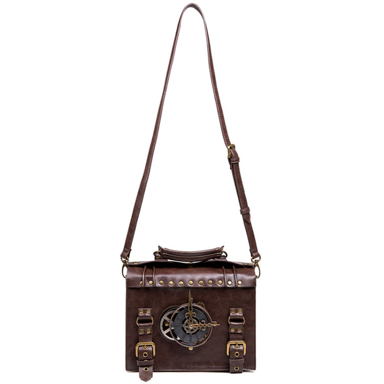 Brown leather-look crossbody bag hanging view with long strap and front gear emblem