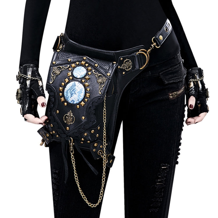 Black one-shoulder crossbody bag with blue gem medallions, gold studs, and chain strap