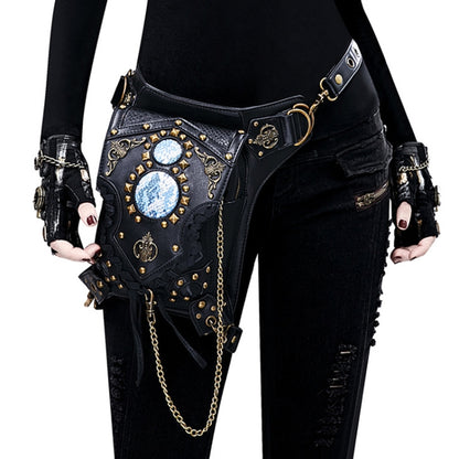Black one-shoulder crossbody bag with blue gem medallions, gold studs, and chain strap