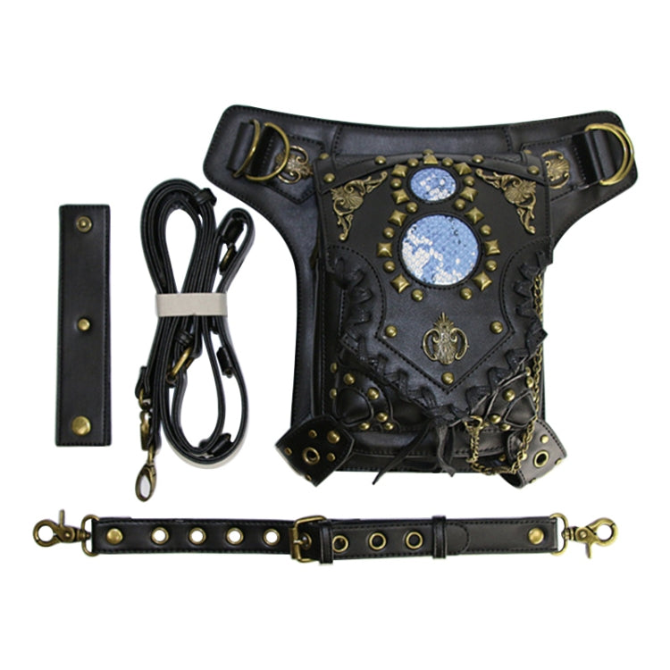 Black crossbody pouch with blue gem panel, studded details, and included strap hardware
