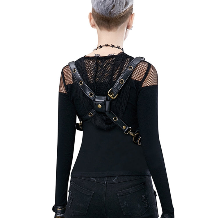 Black crossbody bag worn at back with adjustable straps and metallic buckles