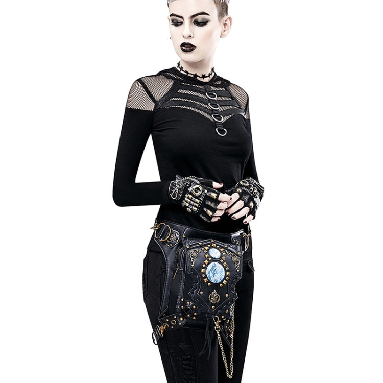 Black crossbody bag with blue gem front panel, gold studs, and dangling chain detail