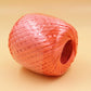 Pink plastic packing rope spool with inner loop, tightly wrapped strapping cord