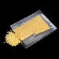 Transparent vacuum bag filled with yellow grains, flat clear plastic pouch
