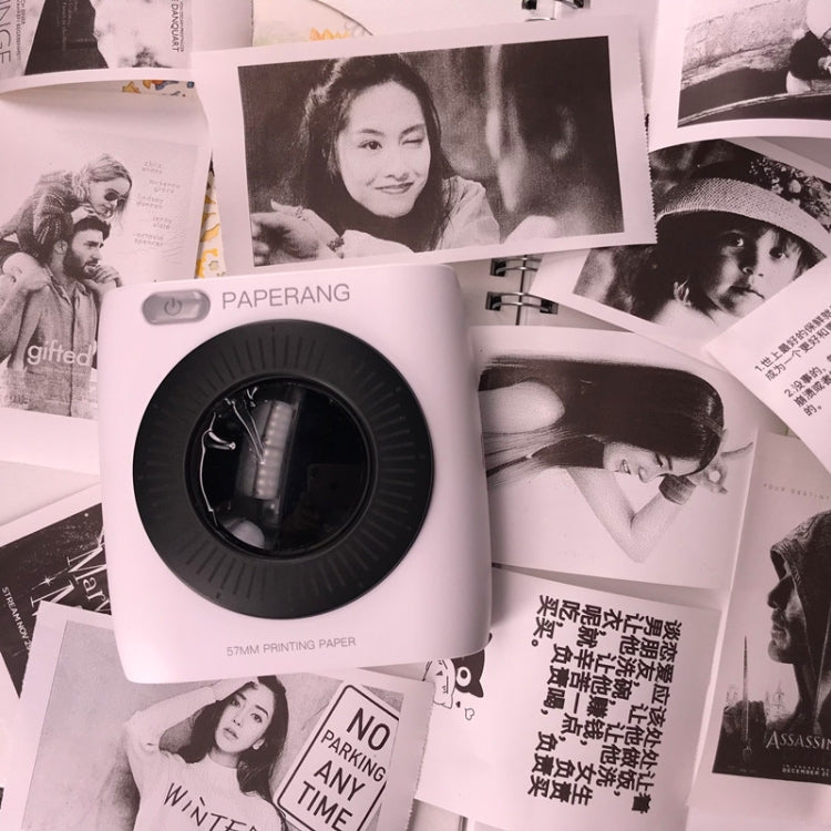 Thermal label printer paper roll with label printer, surrounded by printed label pages