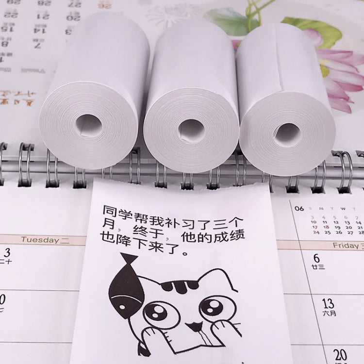 Thermal label printer paper rolls and a cartoon label sheet on a planner