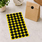 Black round self-adhesive sticker labels sheet with black dot circles on yellow backing