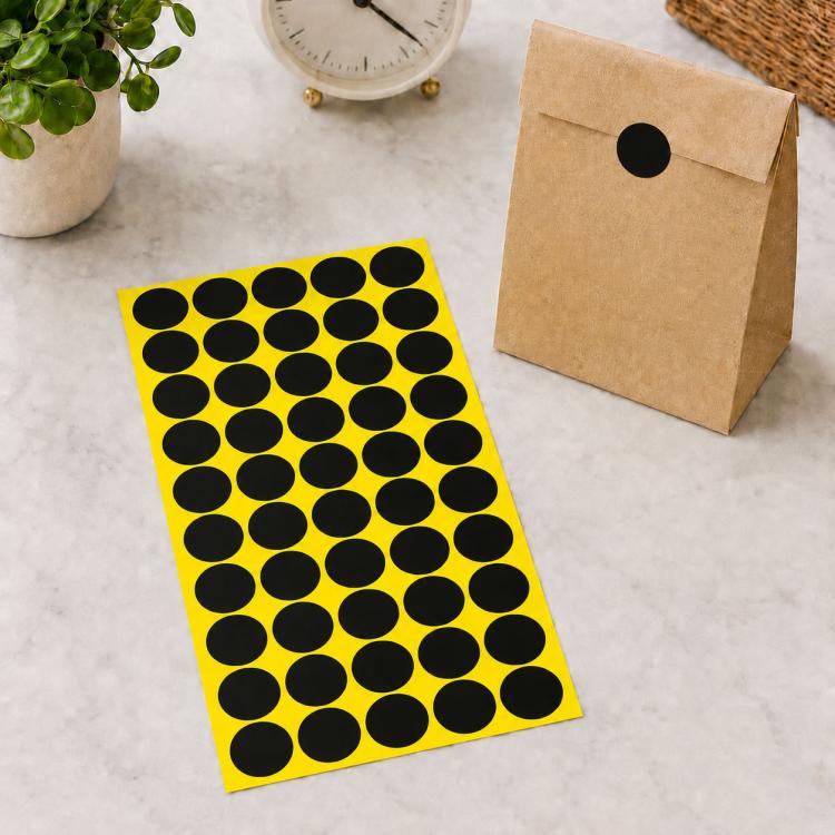 Black round self-adhesive sticker labels sheet with black dot circles on yellow backing