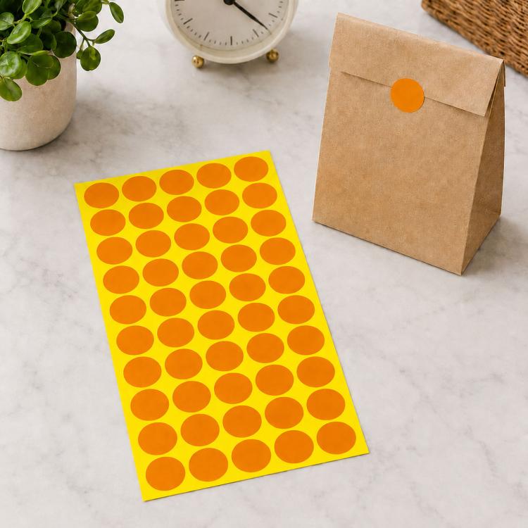 Orange round self-adhesive sticker labels sheet with orange dot circles on yellow backing
