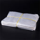 Stack of clear PE plastic packaging bags, tied bundle, 50 x 60 cm