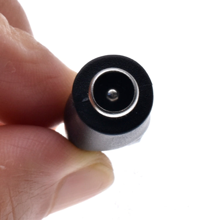 Close-up of black circular DC socket with metal ring and center contact