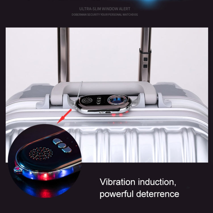 Vibration alarm key fob clipped to suitcase handle with blue LED ring
