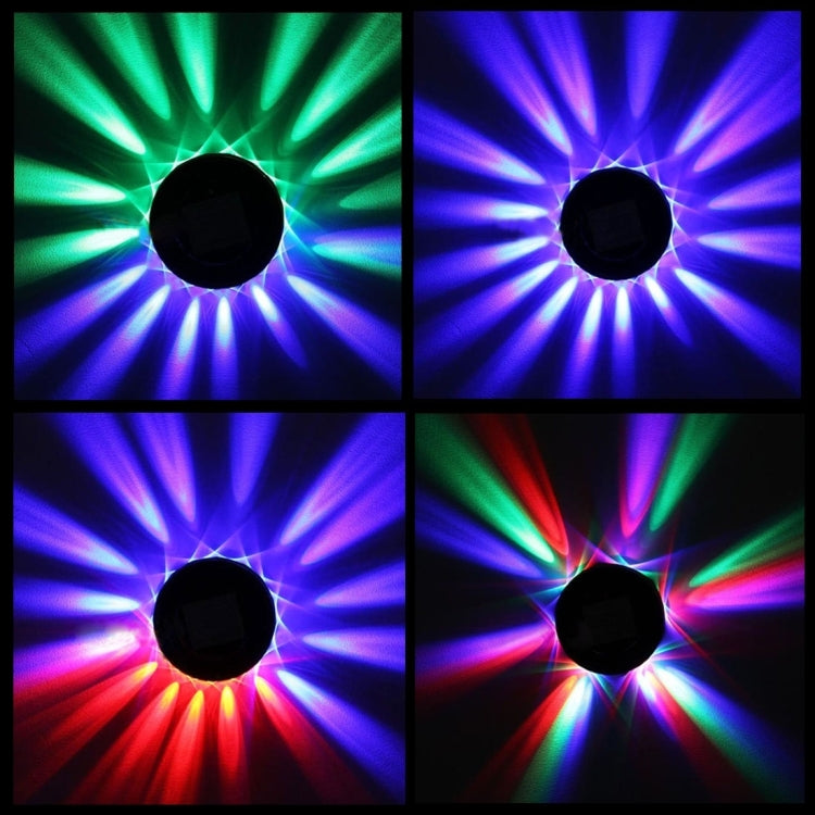 LED projector beam effects in four colors on a dark circular base