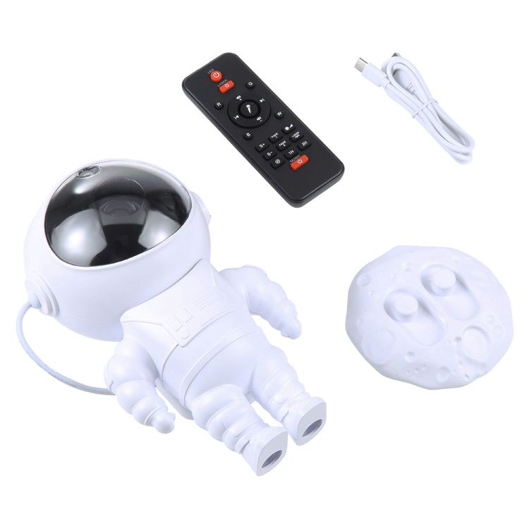 White astronaut projection lamp with black remote control and USB cable