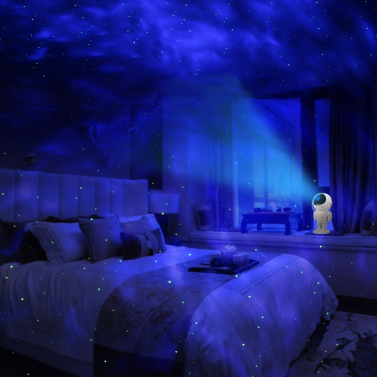 Small white astronaut starry-sky projection night light glowing on bedside