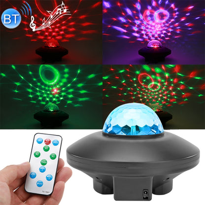 Black laser star projector light with blue faceted dome, shown with Bluetooth remote