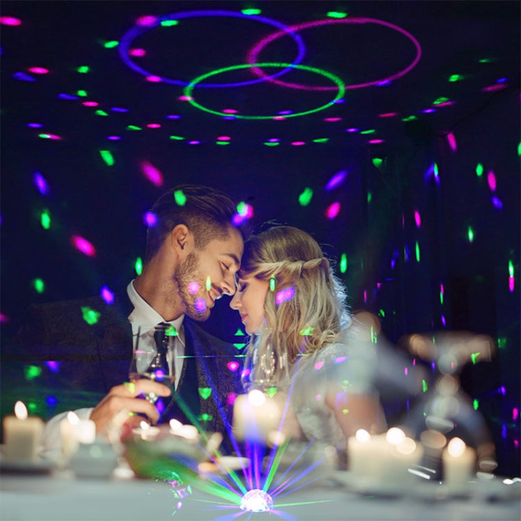 Room filled with colorful disco light projections from a magic ball stage light