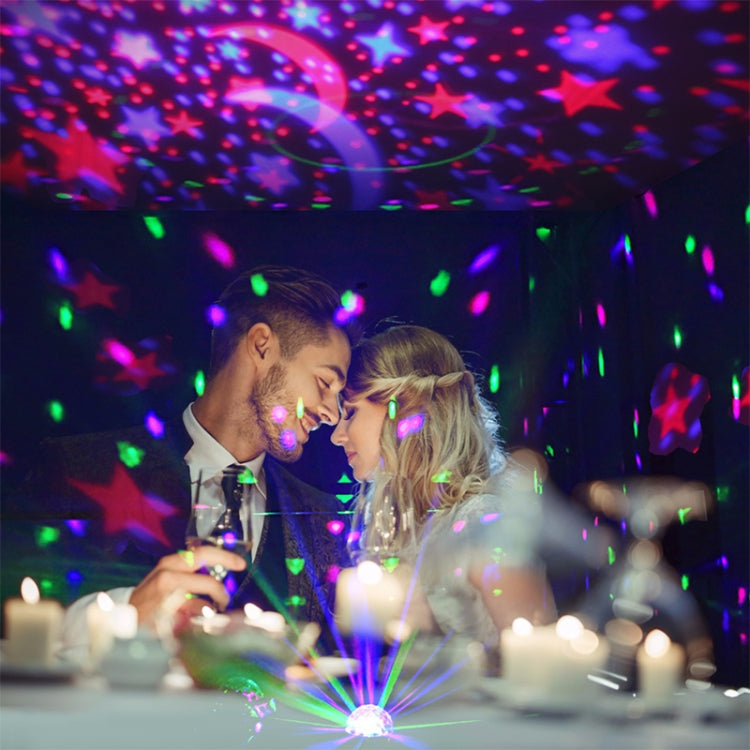 Starry sky stage light projecting colorful stars, moon, and light effects over tabletop
